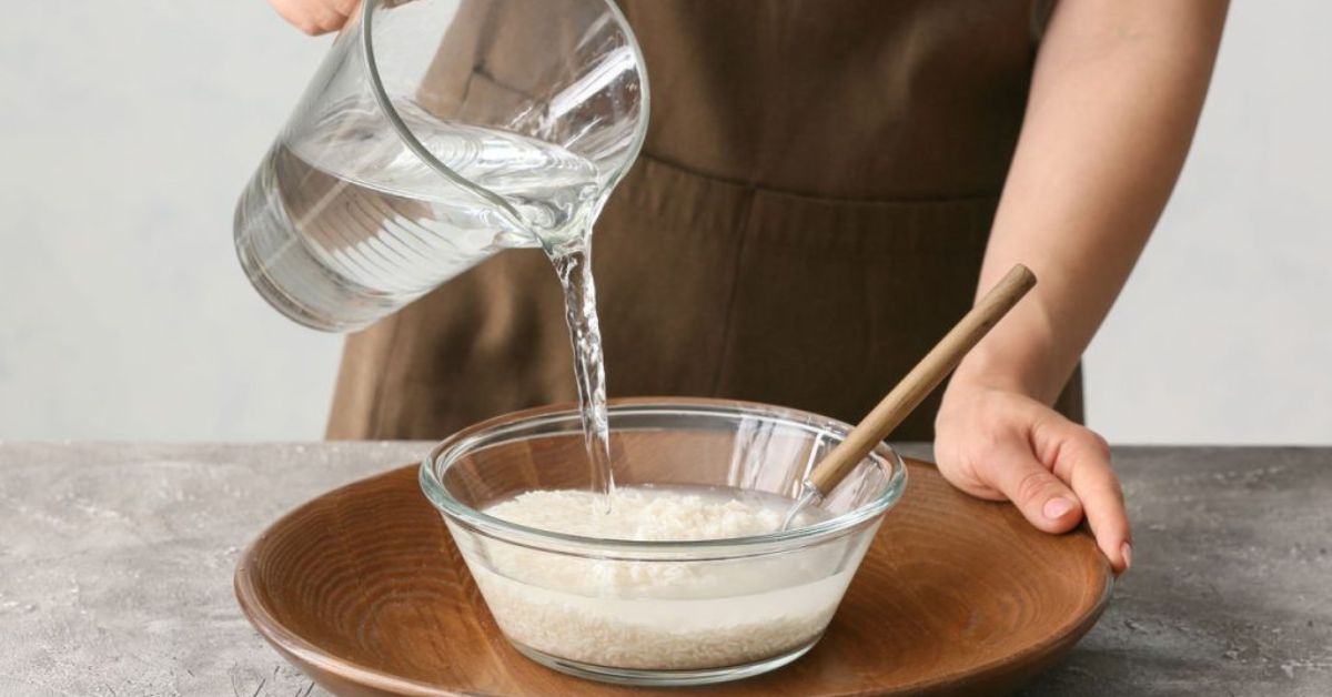 mulher jogando água no arroz para usar como tônico na pele
